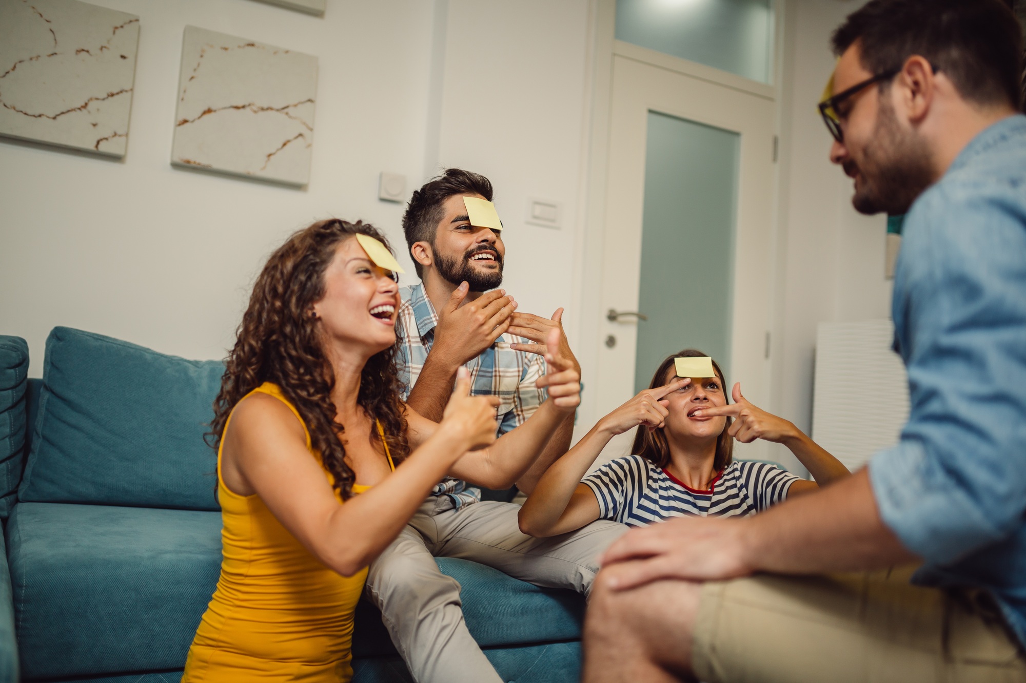 Group of friends are playing social games. Young friends are playing game Guess Your Character.