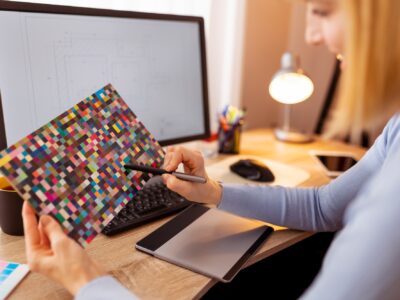 Designer using color palette and drawing pad