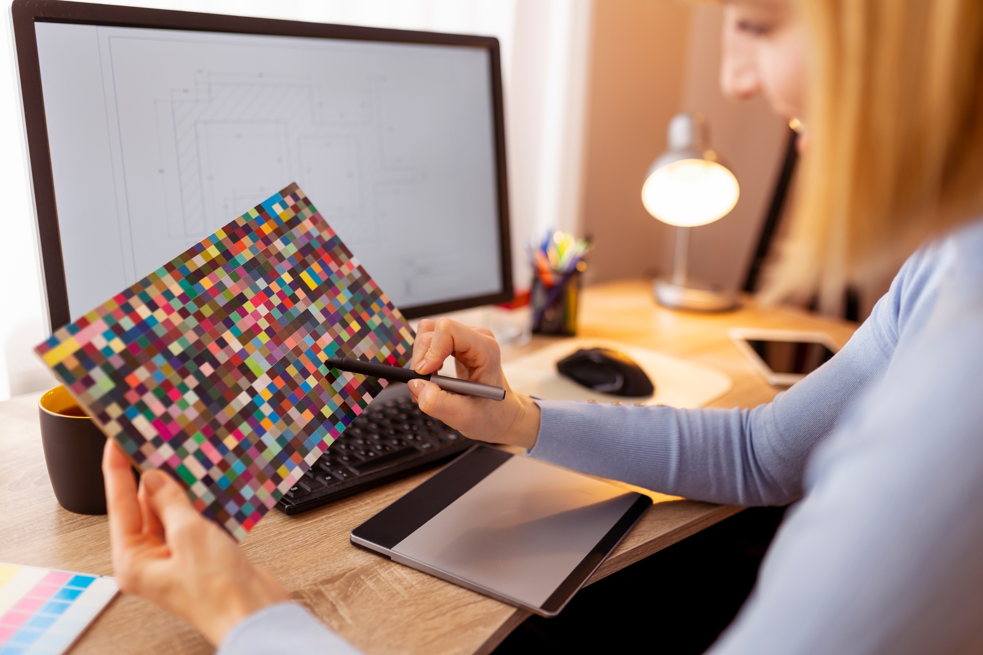 Designer using color palette and drawing pad