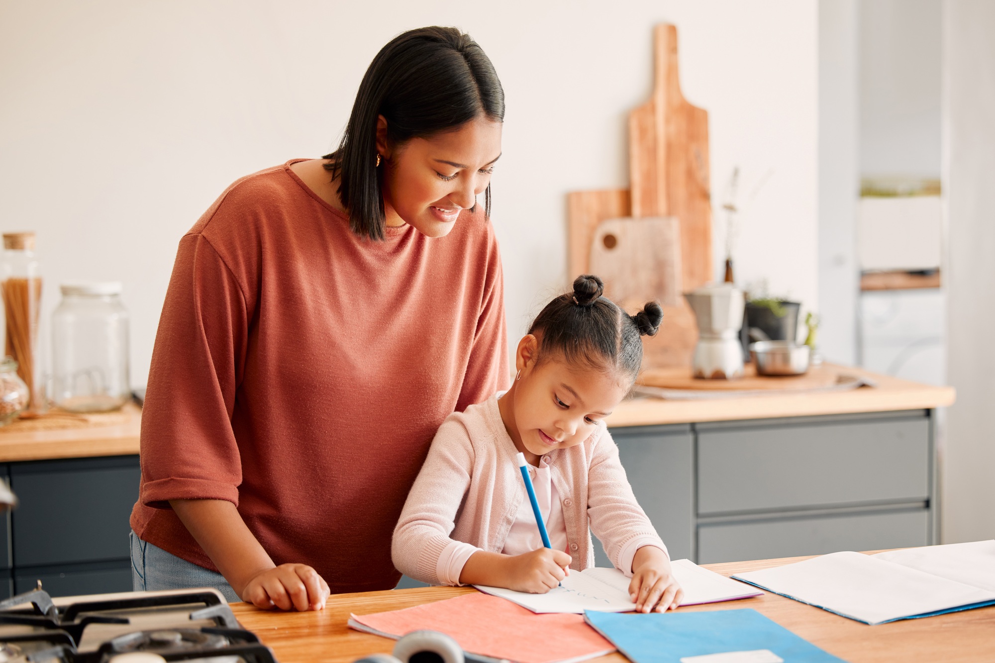 Home school, education and learning child while teaching mother watches daughter draw or colour. Fe