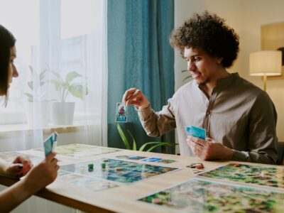 Man Showing Card While Playing Board Game