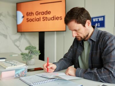 Teacher Grading Tests in School